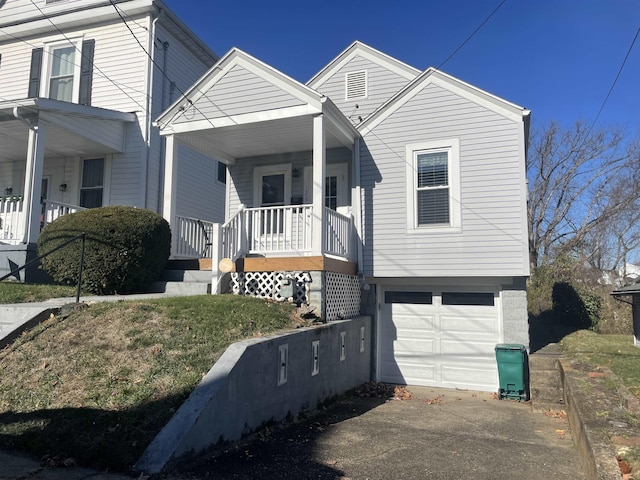 view of front of property with covered porch and a garage