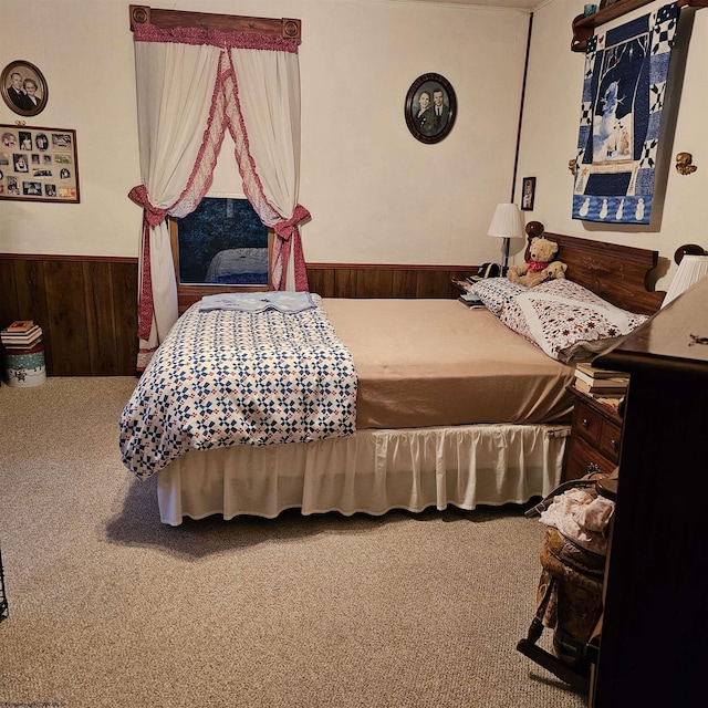 bedroom featuring carpet flooring and wood walls