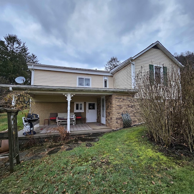 view of front of property with an outdoor hangout area, a patio, and a front yard