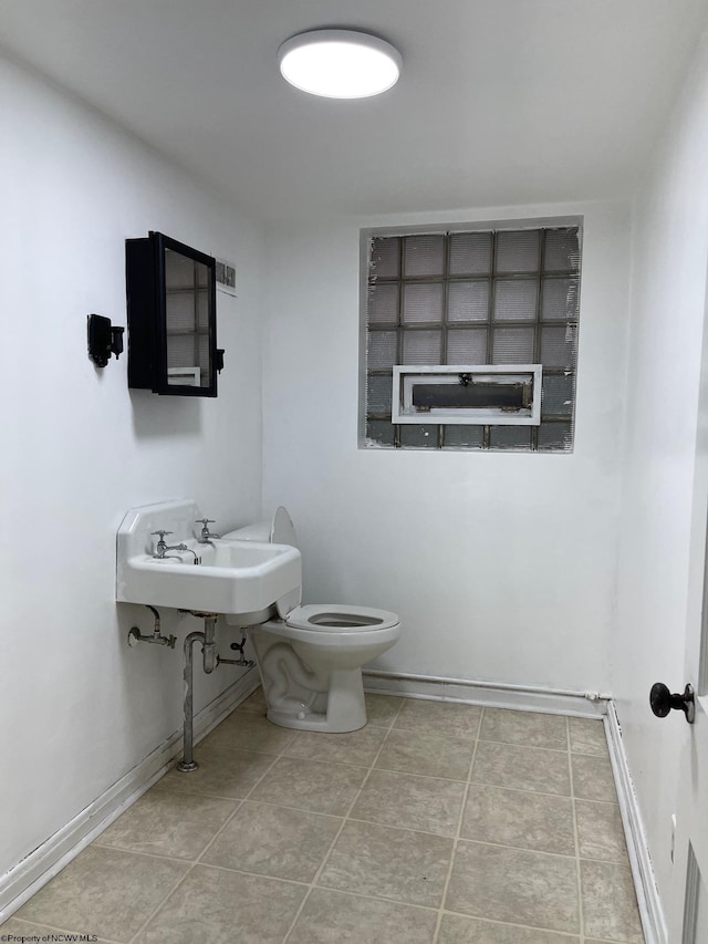 bathroom with tile patterned floors, sink, and toilet