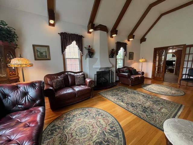 living room featuring high vaulted ceiling, french doors, ceiling fan, beamed ceiling, and wood-type flooring