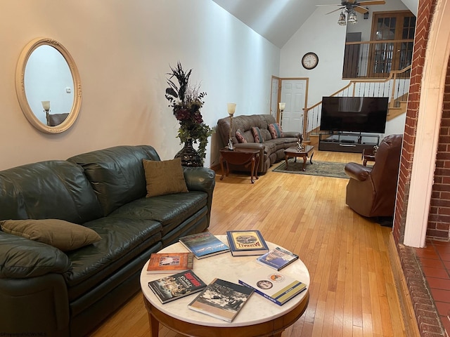 living room featuring hardwood / wood-style floors, ceiling fan, and lofted ceiling