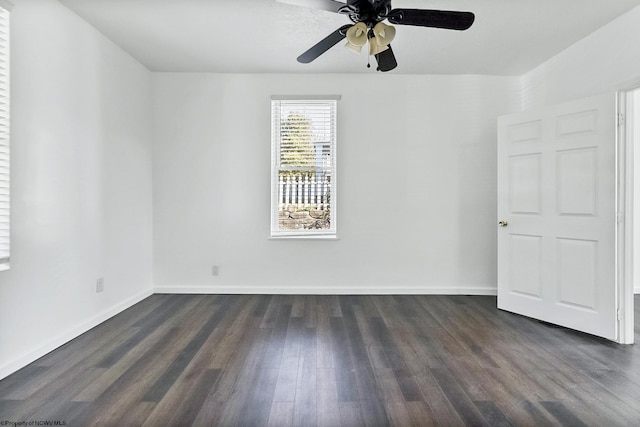 empty room with ceiling fan and dark wood-type flooring