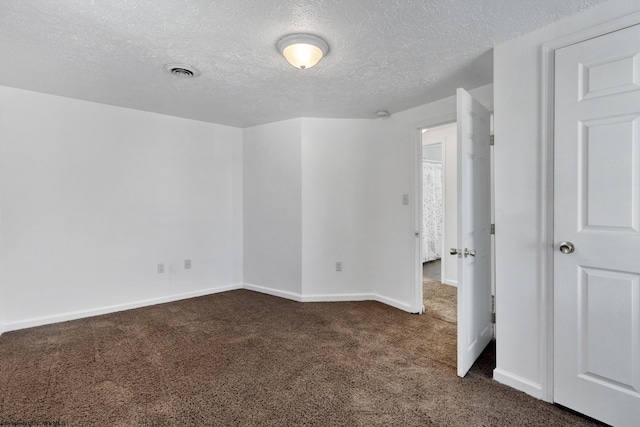 carpeted spare room featuring a textured ceiling