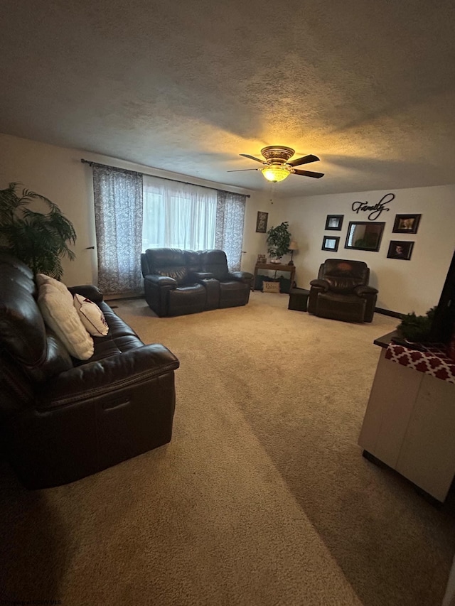 carpeted living room featuring a textured ceiling and ceiling fan