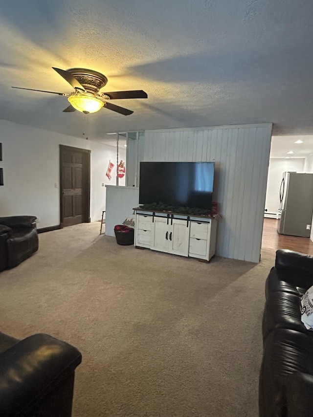 carpeted living room with ceiling fan and a textured ceiling