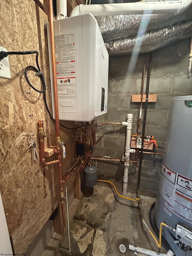 utility room featuring gas water heater and water heater