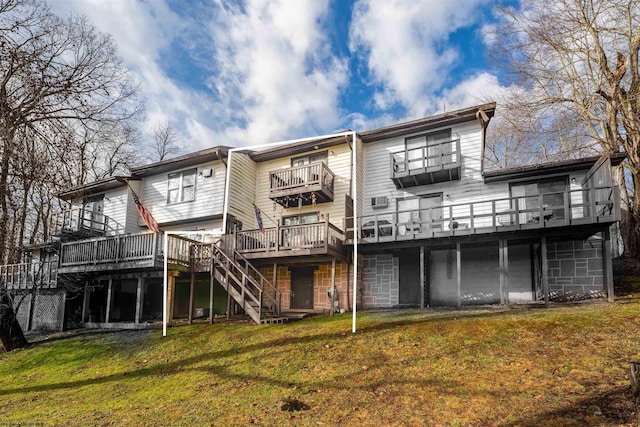 back of house featuring a deck and a lawn