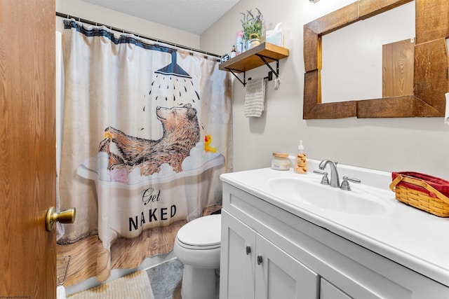 bathroom featuring vanity, a shower with curtain, a textured ceiling, and toilet