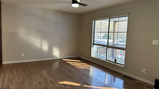 unfurnished room featuring ceiling fan and dark wood-type flooring