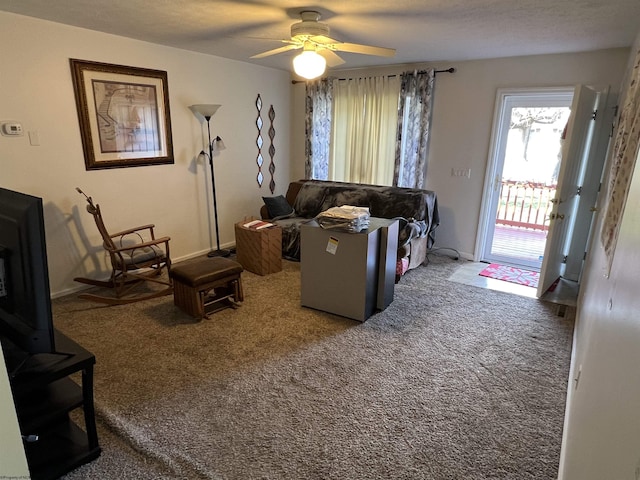 carpeted living room featuring ceiling fan