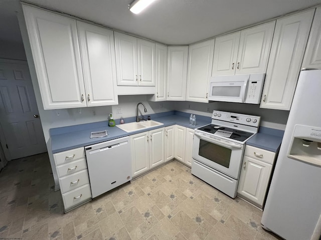 kitchen with white cabinetry, white appliances, and sink