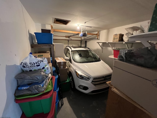 garage featuring refrigerator and a garage door opener