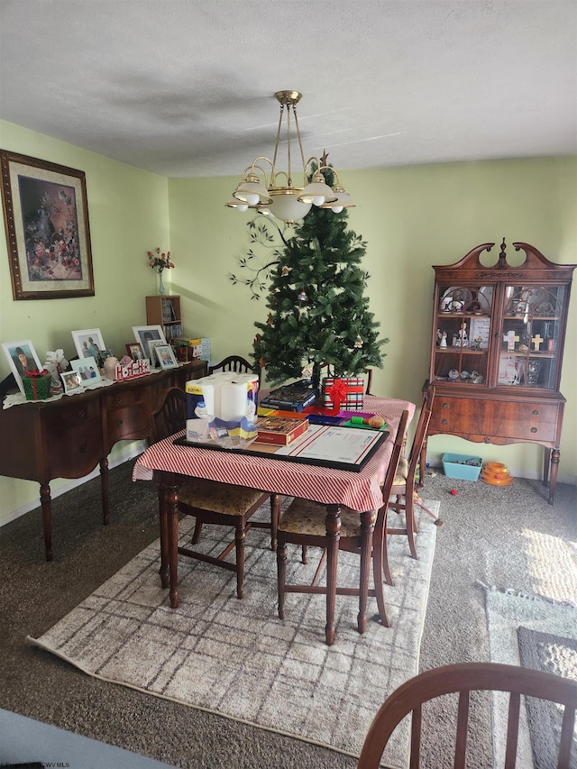 carpeted dining area featuring a textured ceiling