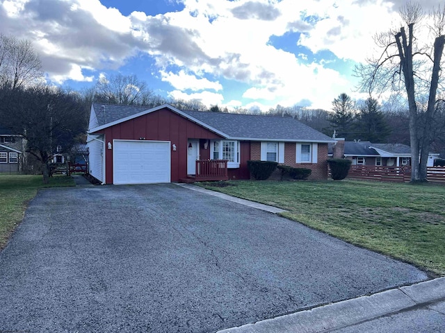 ranch-style home with a garage and a front lawn