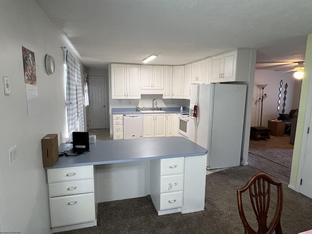 kitchen featuring carpet flooring, ceiling fan, sink, white appliances, and white cabinets