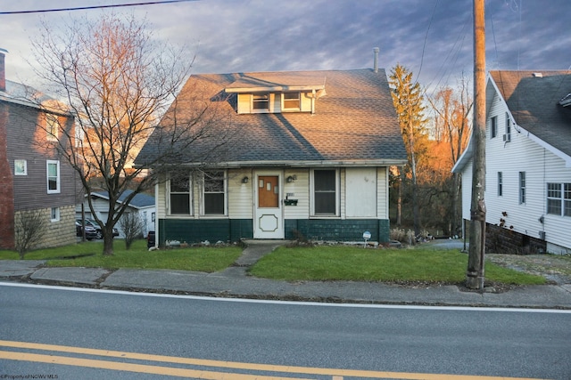 bungalow-style house with a front lawn