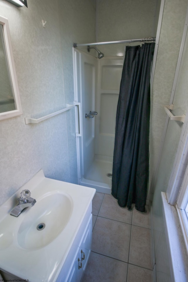 bathroom with tile patterned floors, vanity, and curtained shower