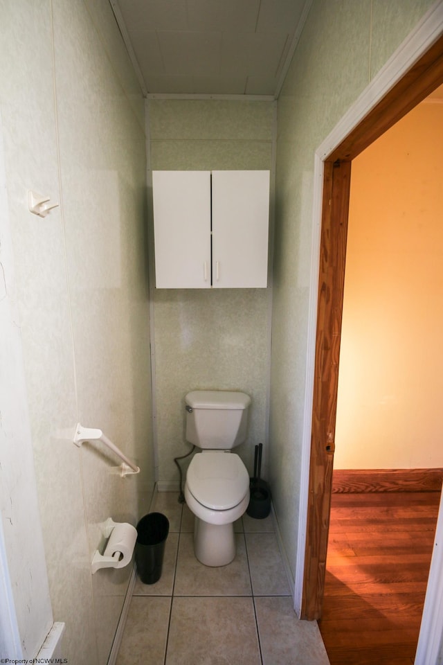 bathroom featuring hardwood / wood-style floors, toilet, and ornamental molding