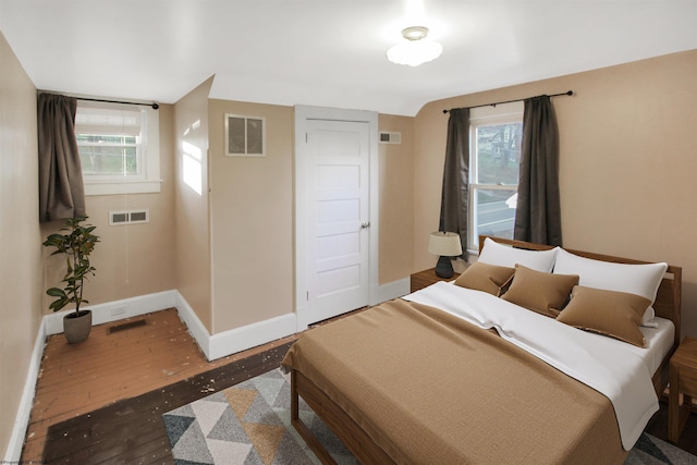 bedroom with dark hardwood / wood-style flooring