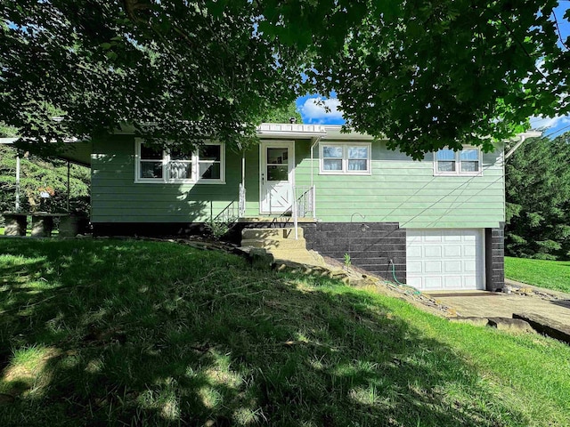 view of front of property with a front yard and a garage