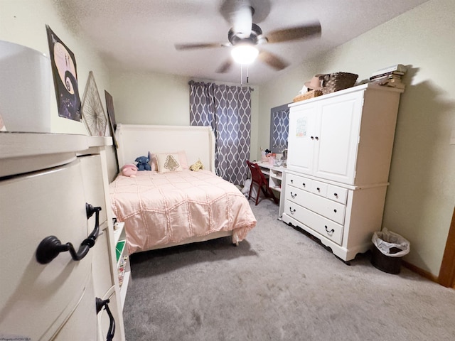 bedroom featuring light carpet, a textured ceiling, and ceiling fan