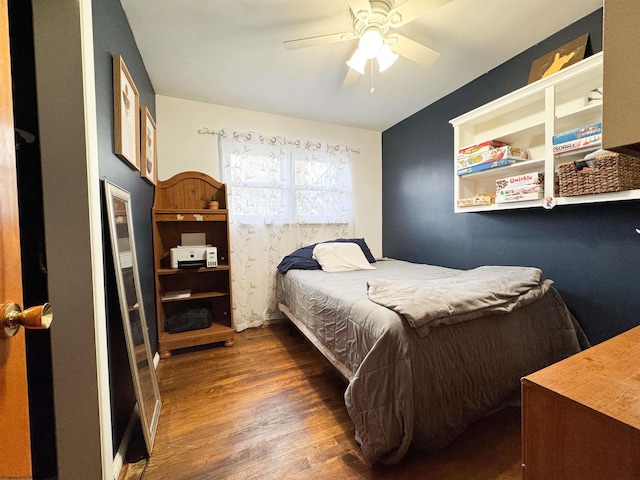 bedroom with dark hardwood / wood-style flooring and ceiling fan