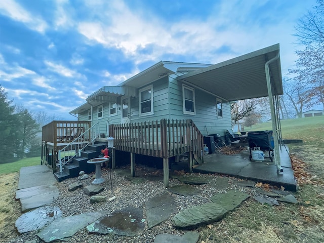 back of house with a wooden deck