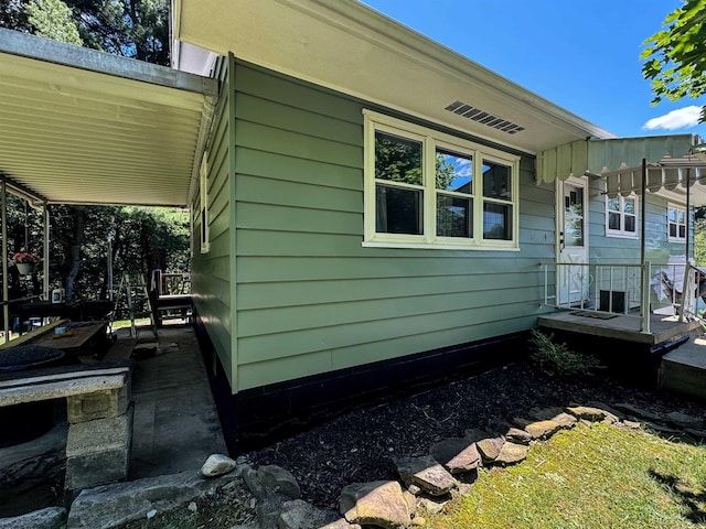 view of property exterior featuring covered porch