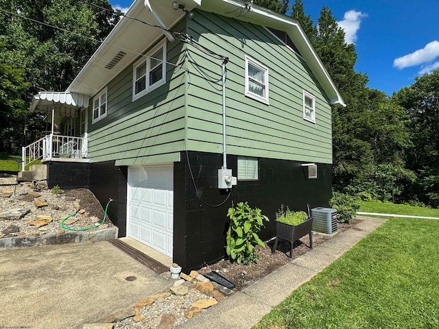 view of property exterior featuring cooling unit and a garage