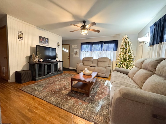 living room with wood-type flooring and ceiling fan