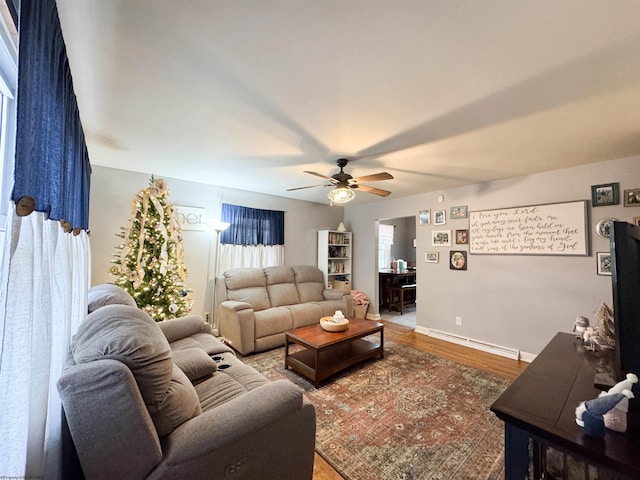 living room featuring ceiling fan, a baseboard radiator, and hardwood / wood-style flooring