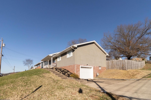 view of side of property featuring a yard and a garage