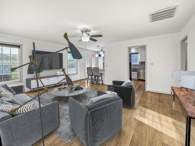 living room featuring a wealth of natural light, hardwood / wood-style floors, and ceiling fan