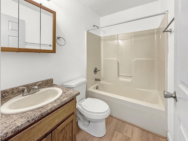 full bathroom with shower / bath combination, vanity, hardwood / wood-style flooring, and toilet