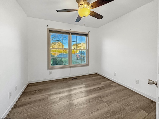 unfurnished room featuring ceiling fan and wood-type flooring