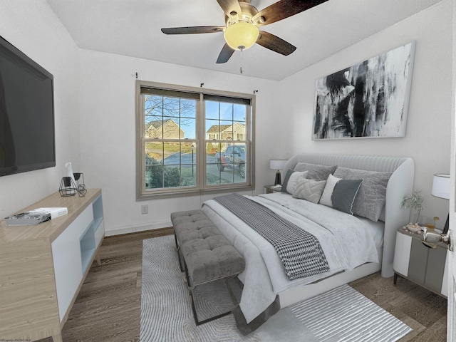 bedroom featuring ceiling fan and dark hardwood / wood-style floors