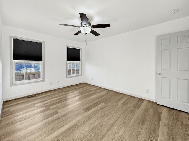 empty room featuring light hardwood / wood-style flooring and ceiling fan