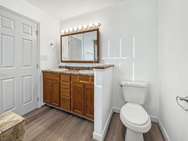 bathroom featuring hardwood / wood-style flooring, vanity, and toilet