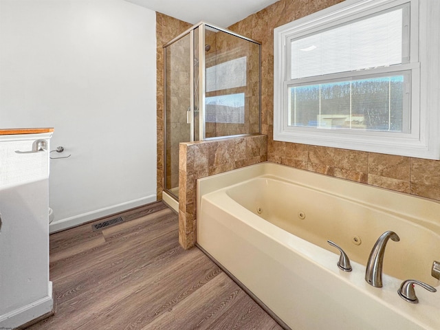 bathroom with hardwood / wood-style flooring and separate shower and tub