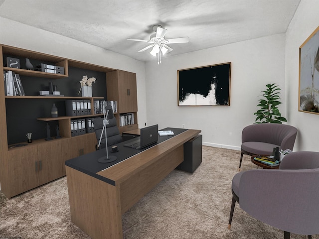 carpeted home office with ceiling fan