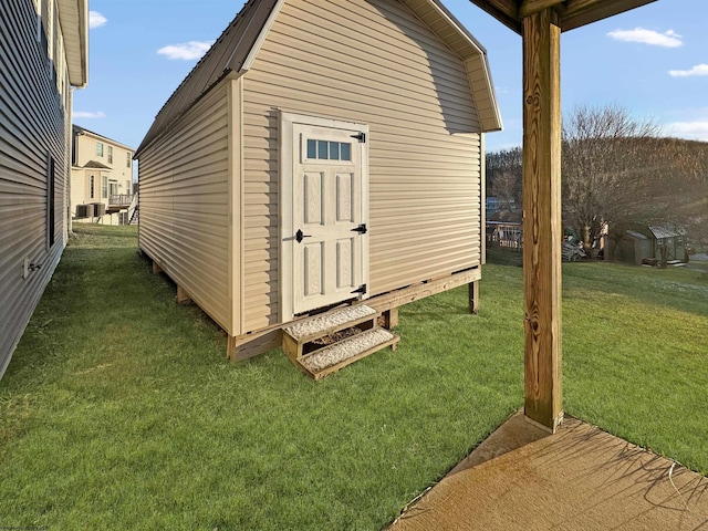 view of outbuilding featuring a lawn