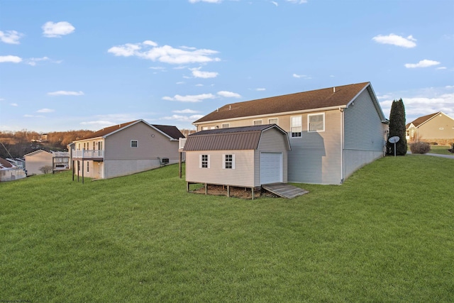 back of house featuring a yard and a storage shed