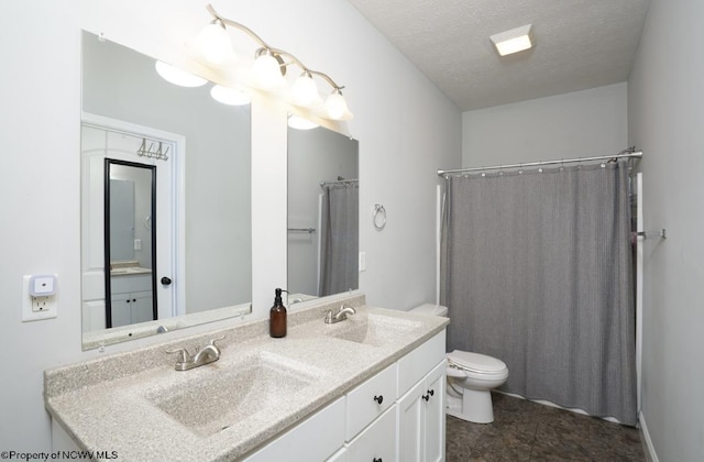 bathroom featuring vanity, a shower with curtain, a textured ceiling, and toilet