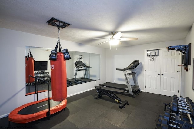 exercise area featuring a textured ceiling and ceiling fan