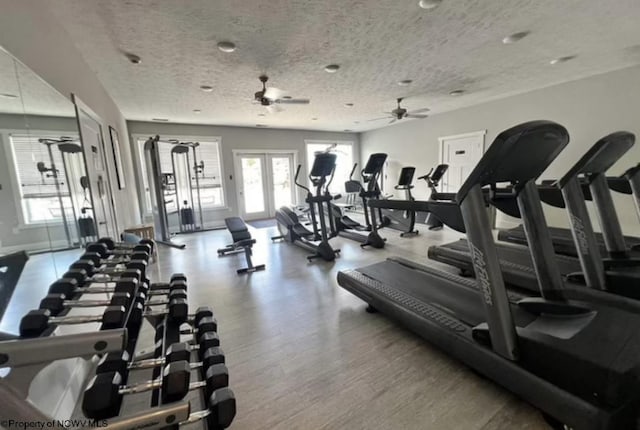 exercise room with ceiling fan, wood-type flooring, a textured ceiling, and french doors