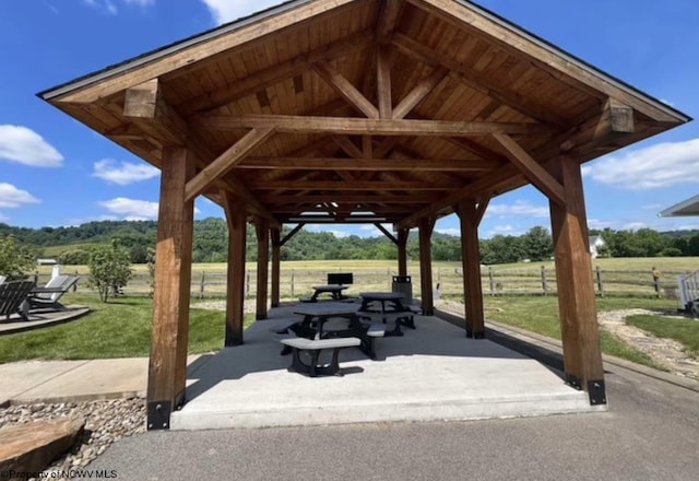 view of property's community featuring a gazebo, a rural view, and a patio