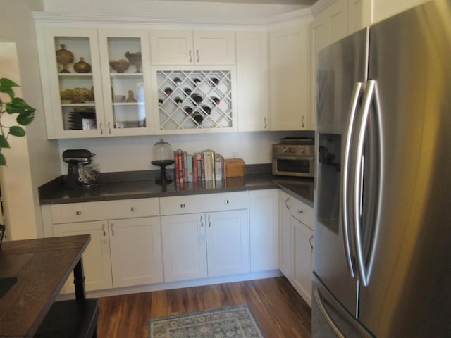 kitchen featuring white cabinetry, dark hardwood / wood-style floors, and stainless steel refrigerator with ice dispenser