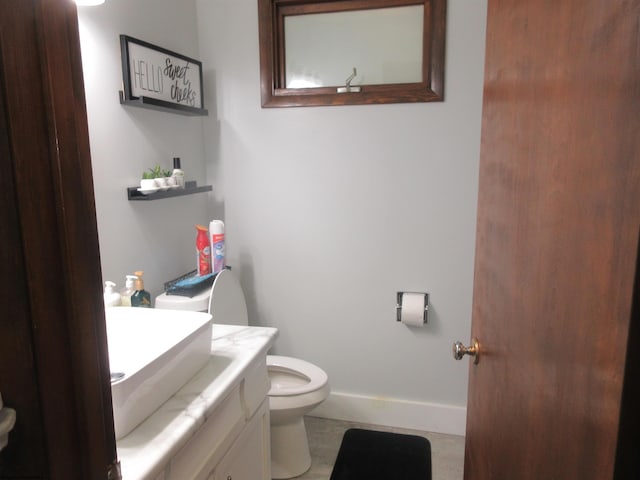 bathroom featuring tile patterned floors, vanity, and toilet