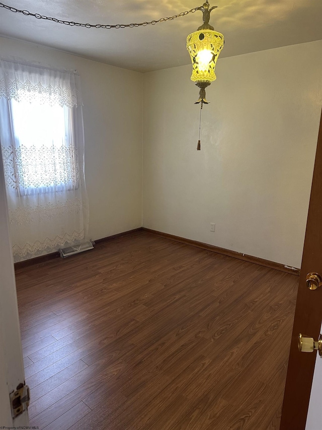 spare room featuring dark hardwood / wood-style flooring